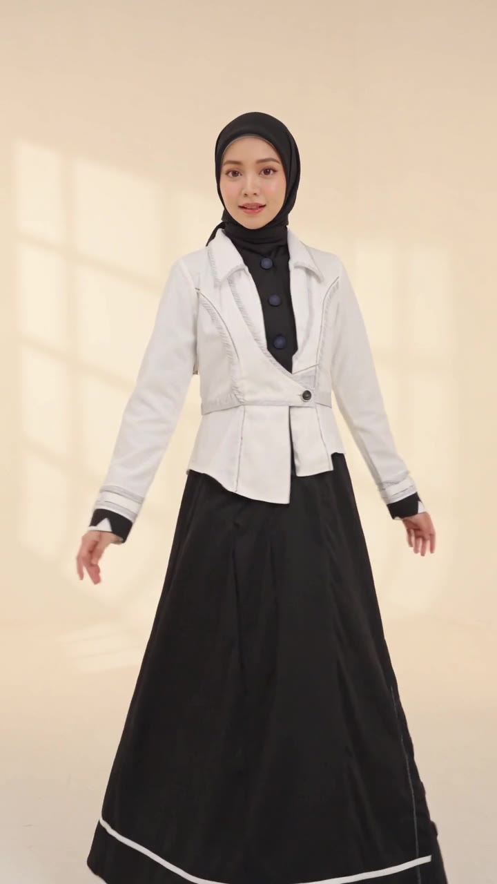 Lydia Farida walking under courtyard arches in a cream hijab